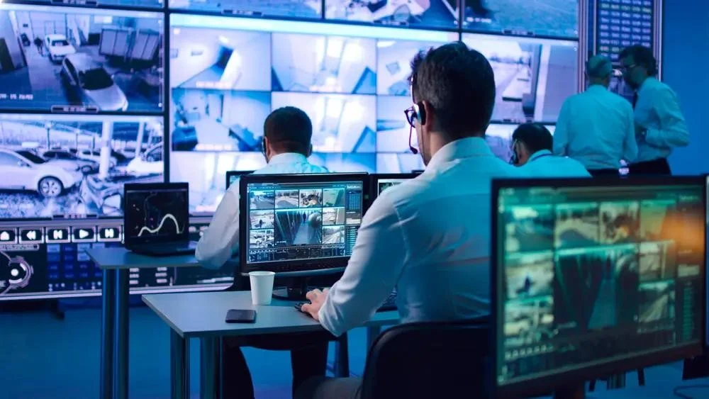 A monitoring operator working across multiple live camera feeds
