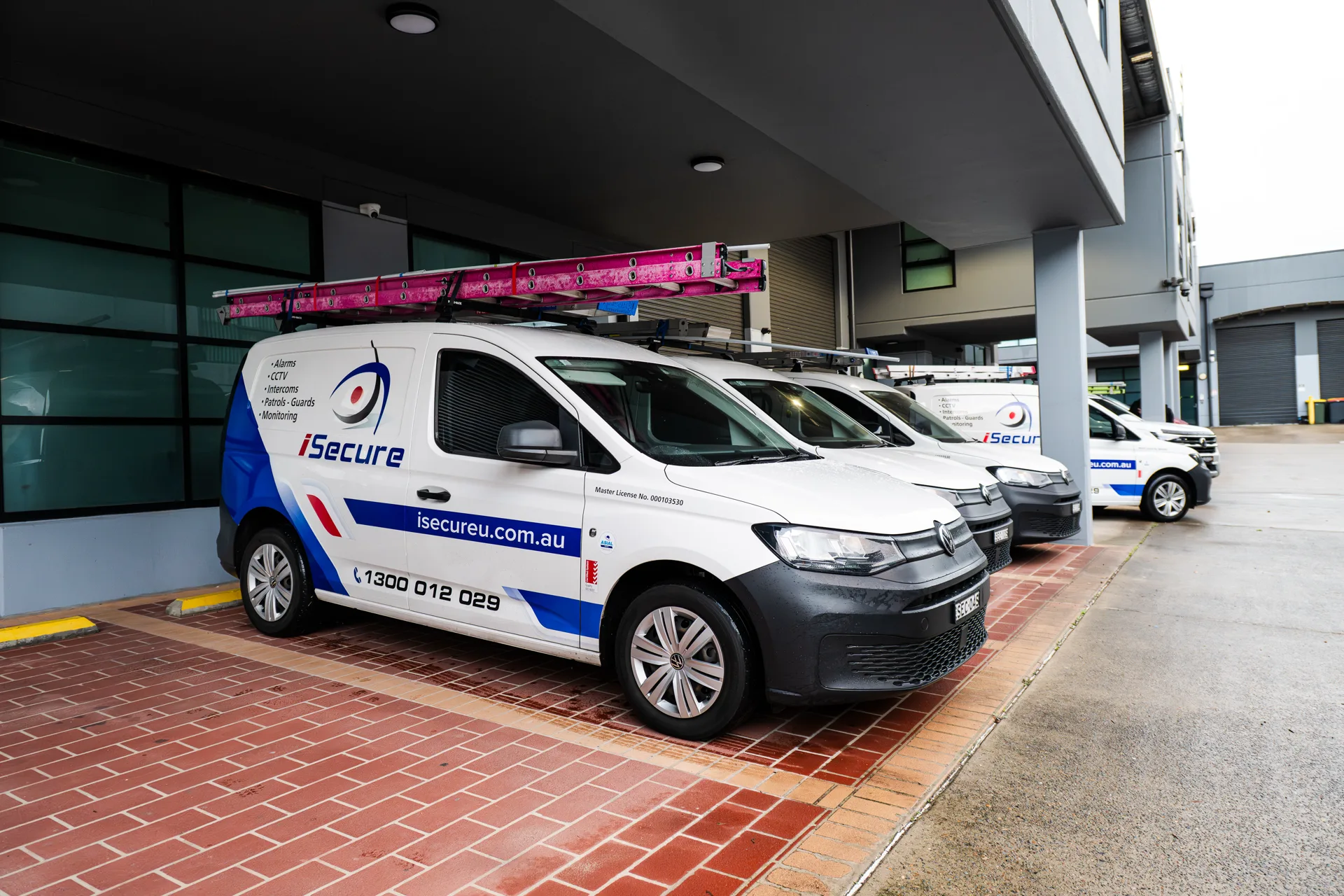 iSecure vans lined up under the headquarters awning