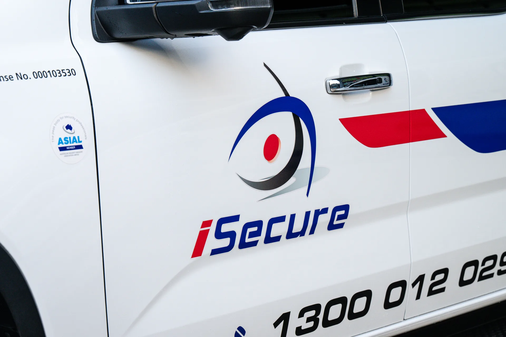 The iSecure logo and ASIAL member sticker on a van door