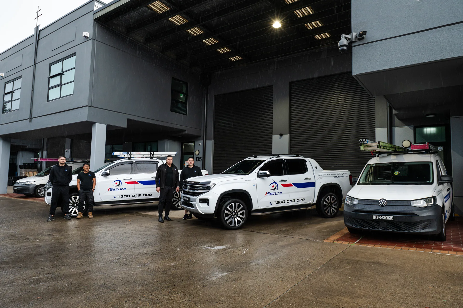 The iSecure team standing with the fleet at Kingsgrove