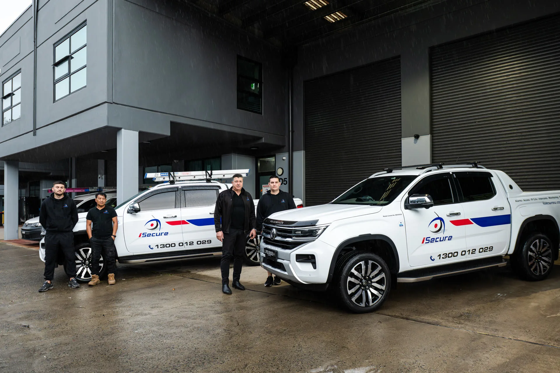 The iSecure team standing with their vehicles at the Kingsgrove headquarters