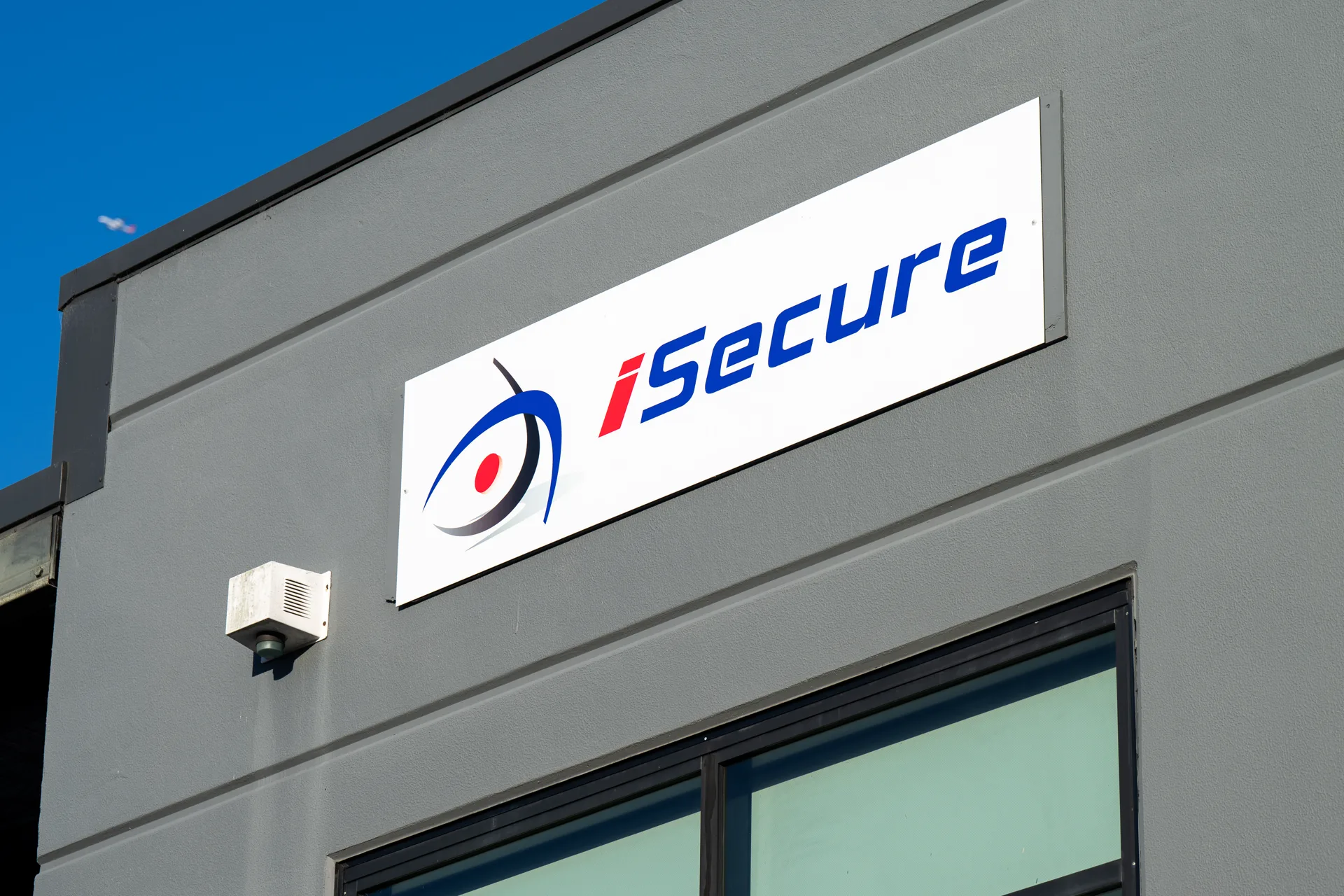 The iSecure sign on the Kingsgrove headquarters against a blue sky