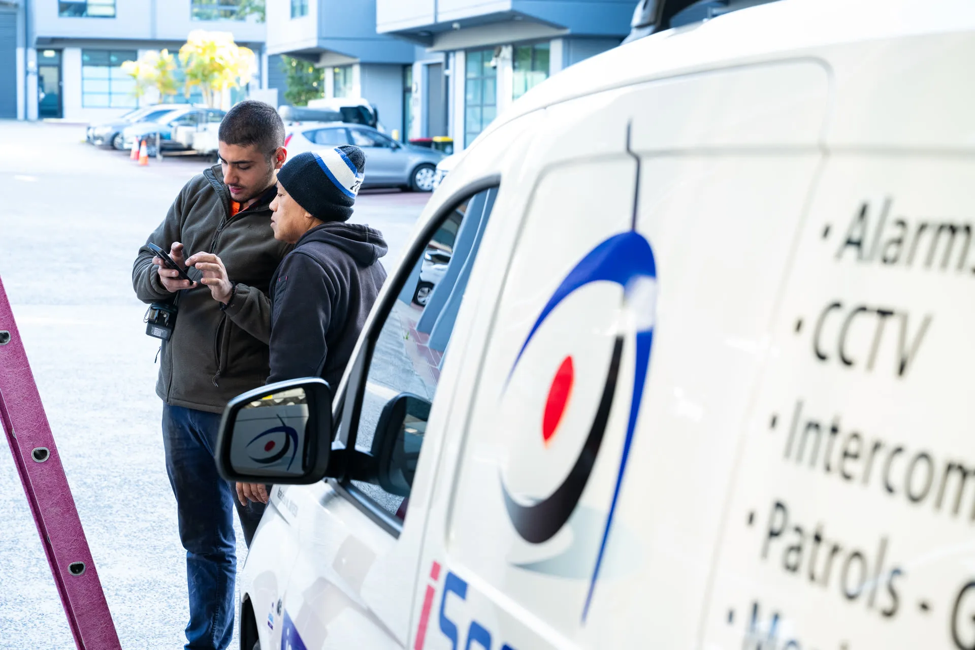 Technicians planning beside the iSecure van