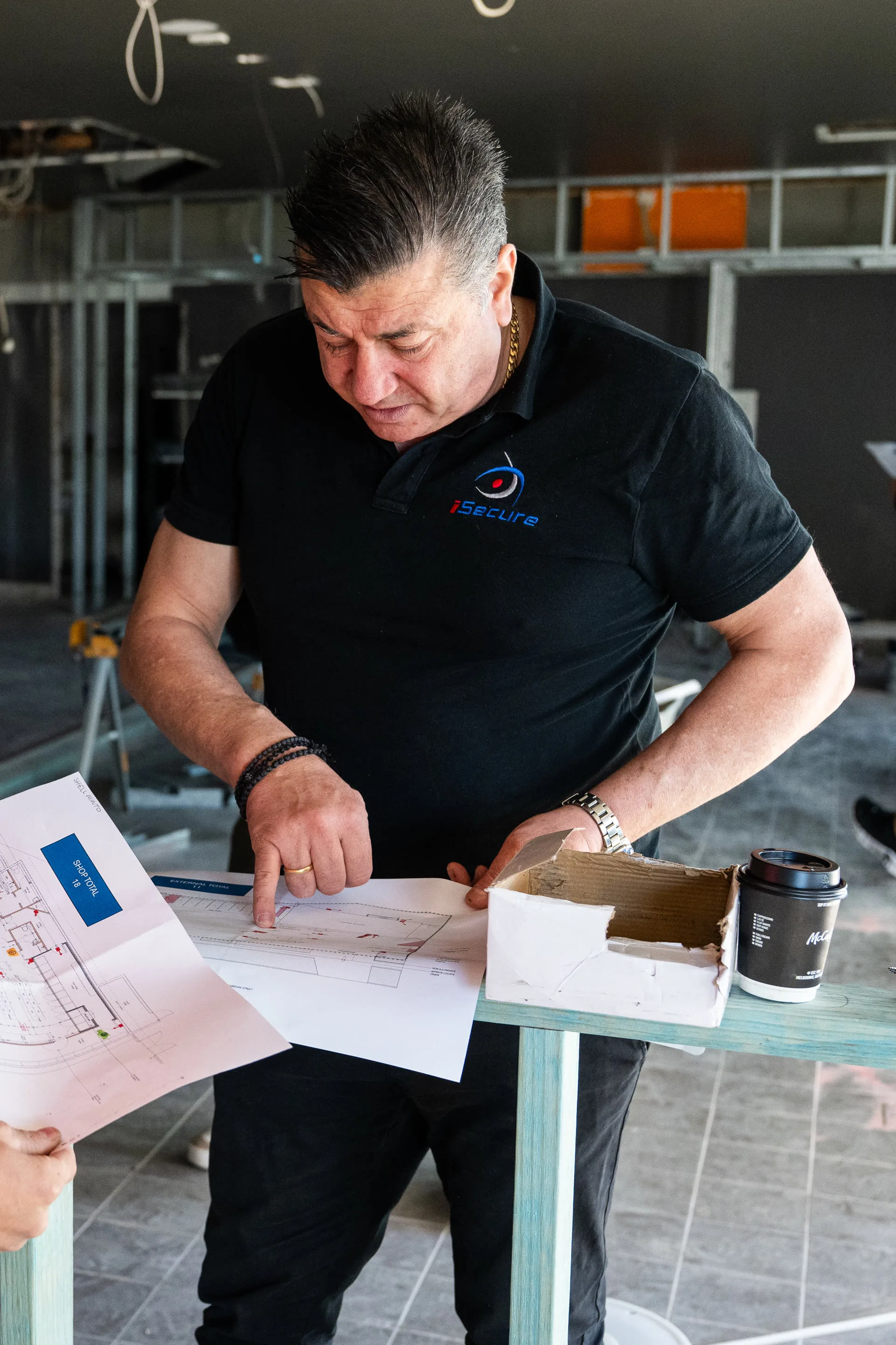 An iSecure technician working through site plans on a job