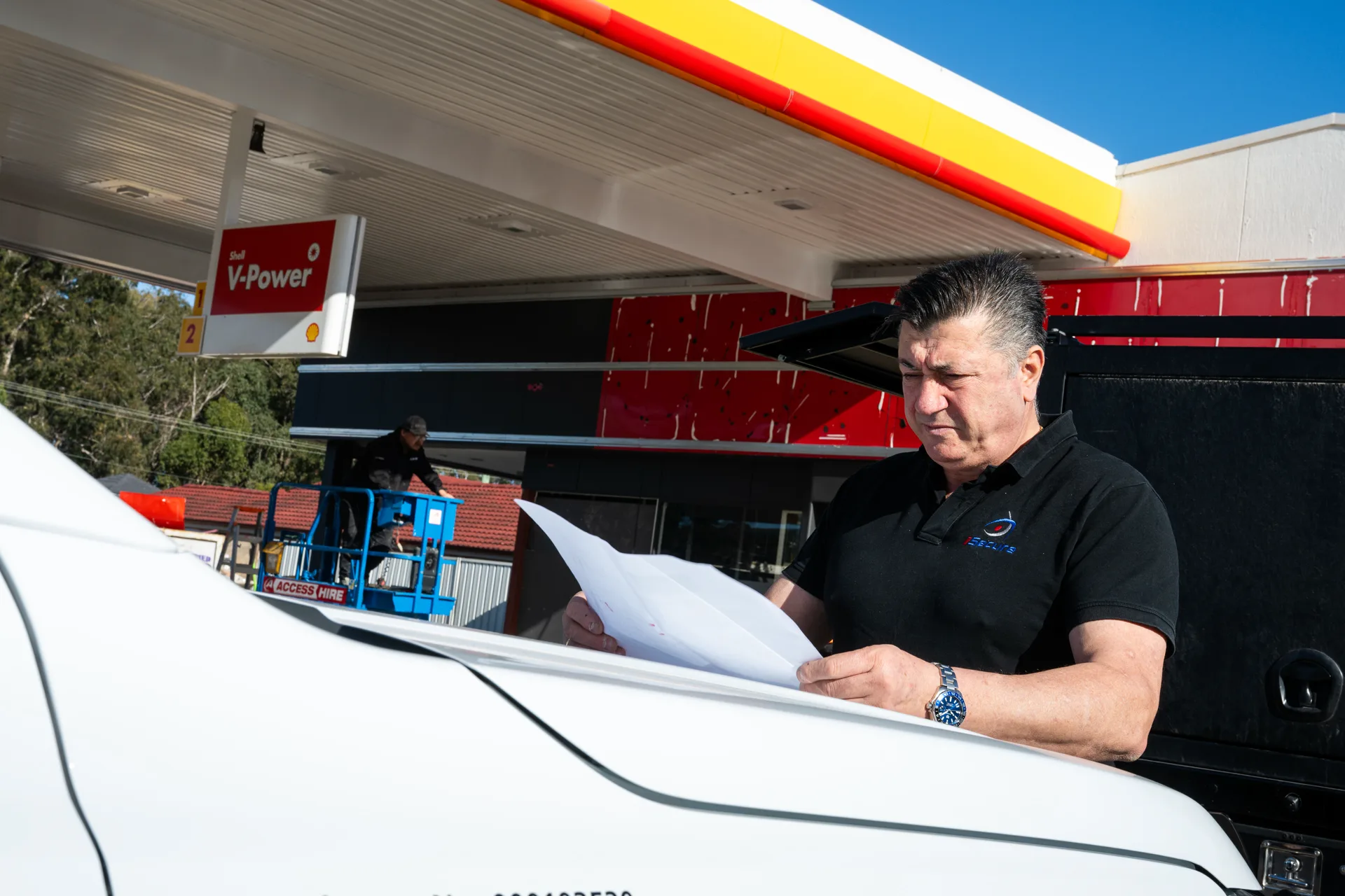 An iSecure director reviewing site plans on a commercial job