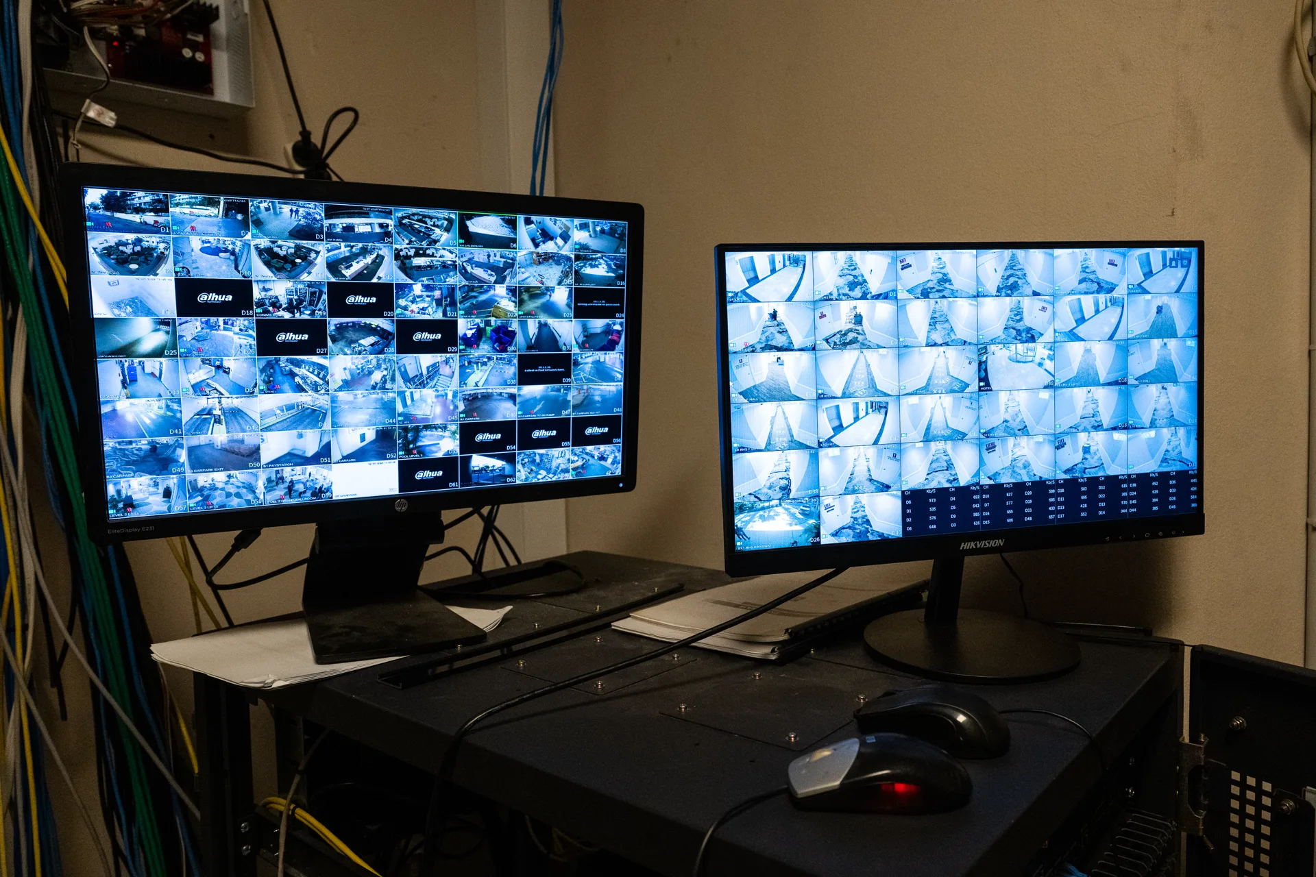 Two screens showing camera feeds from multiple sites