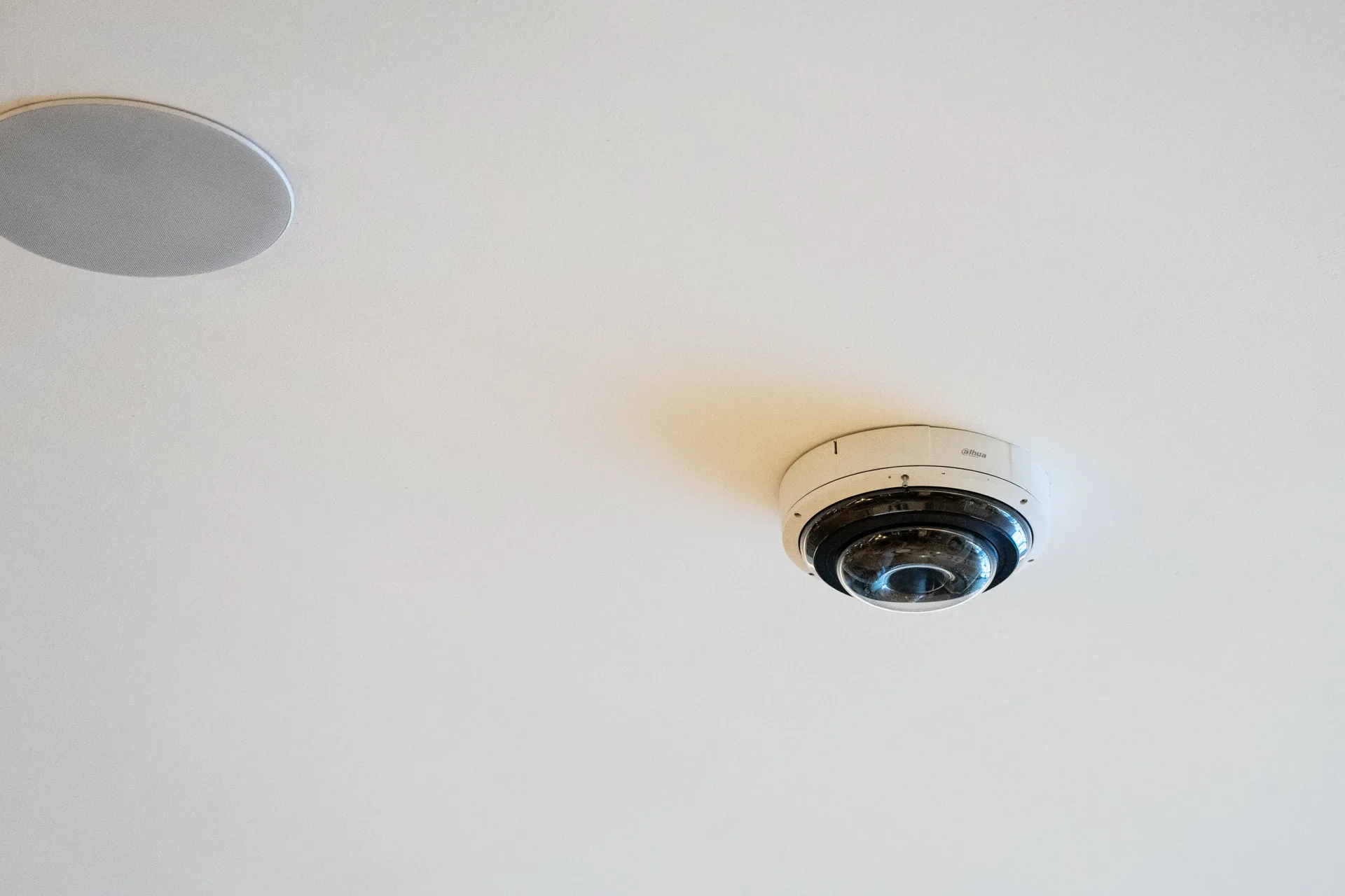 A white dome camera installed on a ceiling