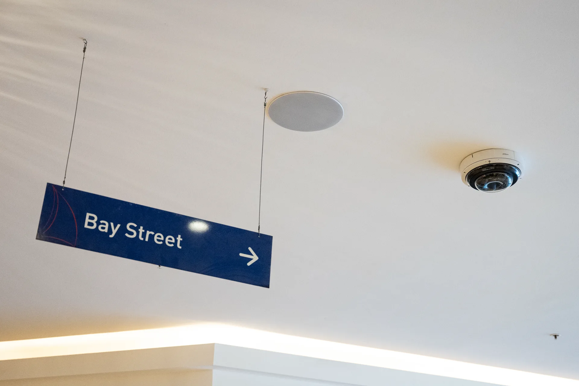 A ceiling camera covering a shopping centre walkway