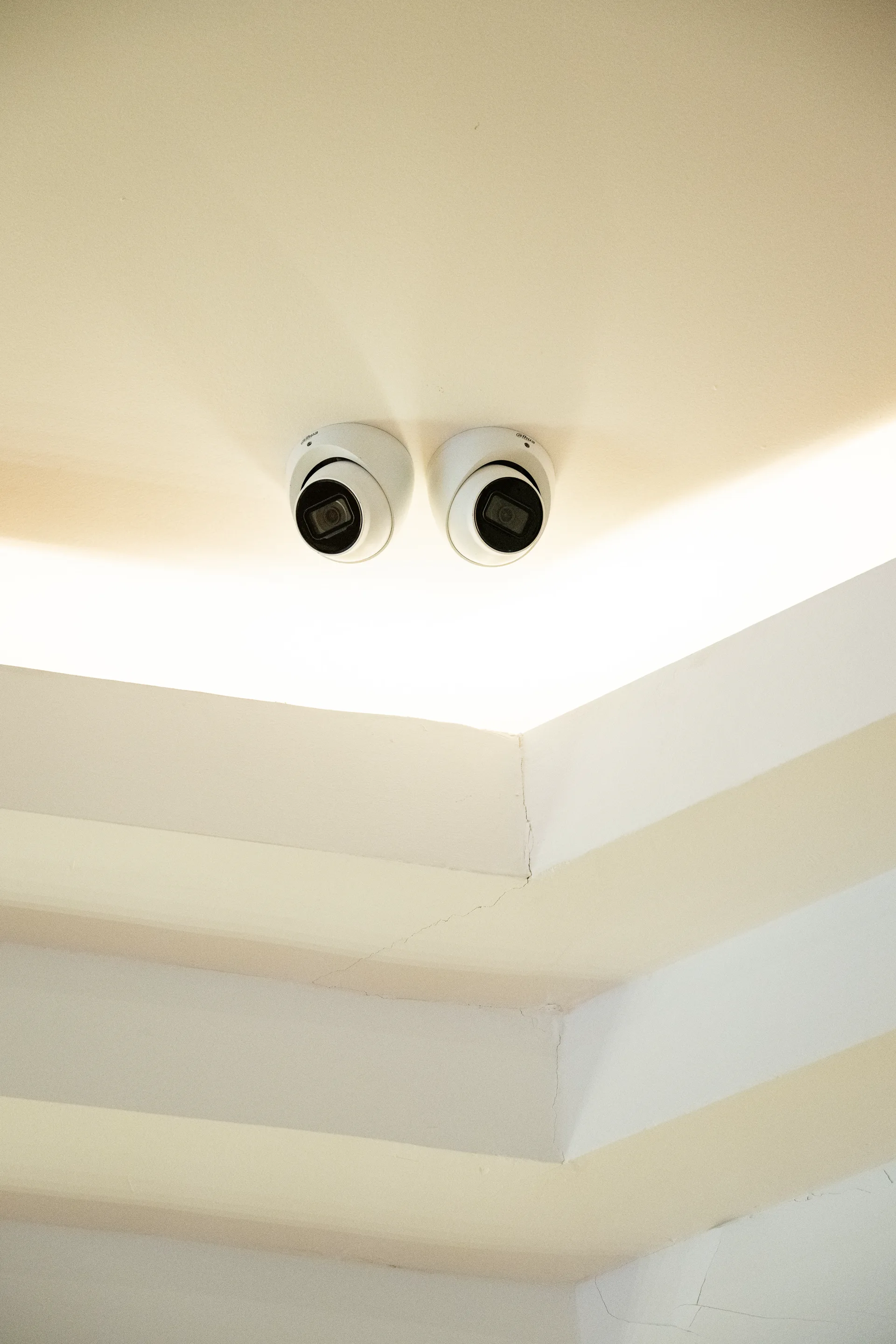 Twin dome cameras protecting a warmly lit interior