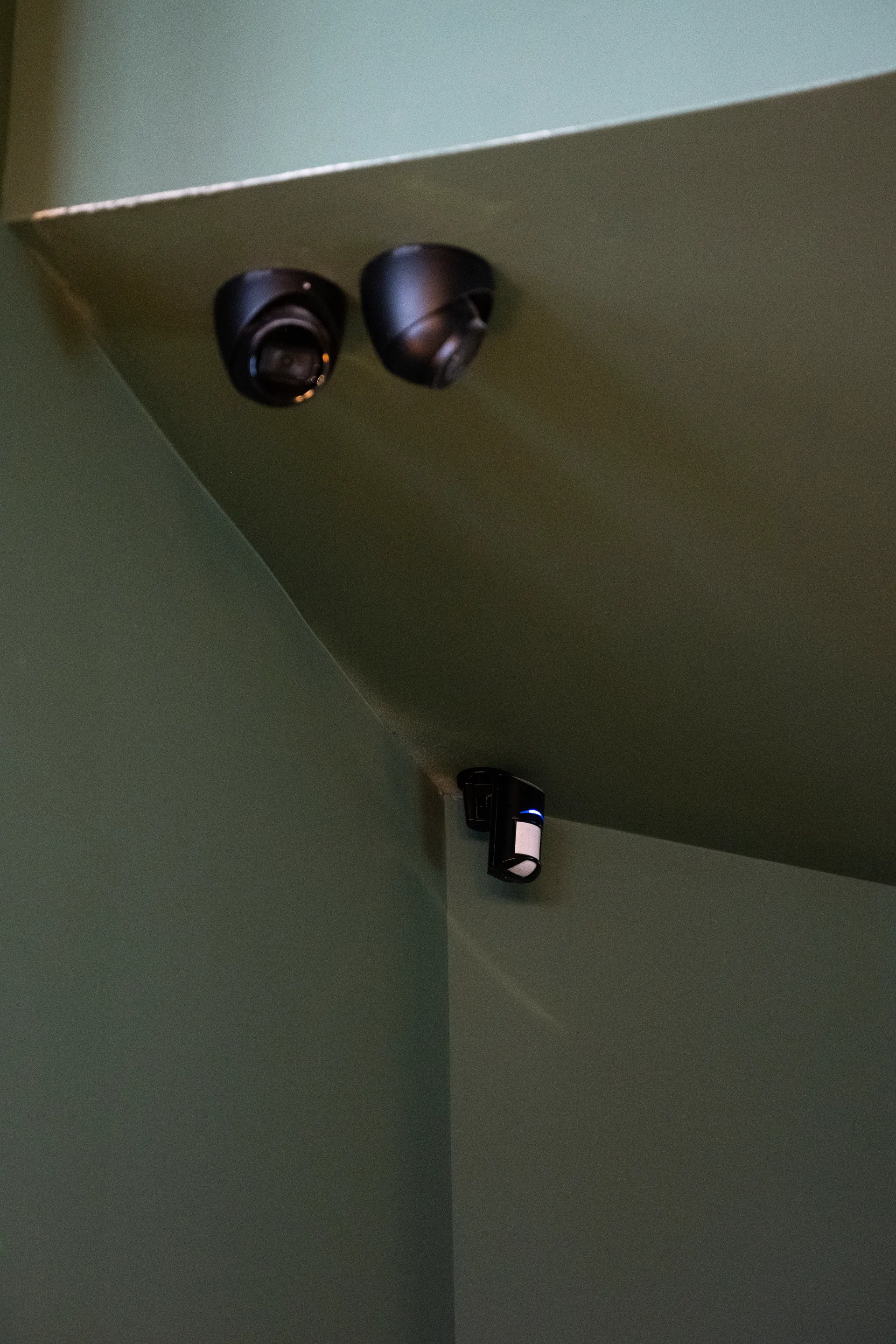 Dome cameras and a motion sensor covering a stairwell