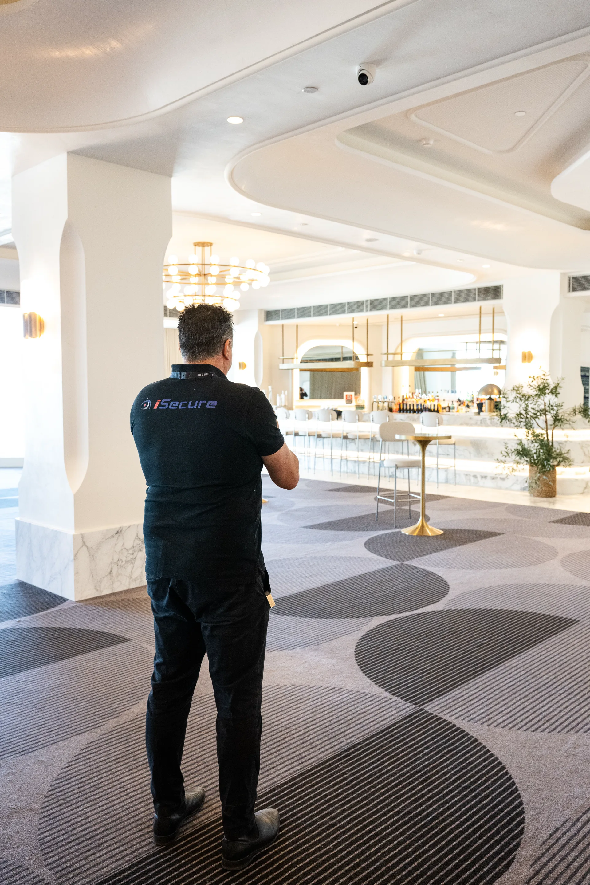An iSecure technician checking coverage in a hotel bar