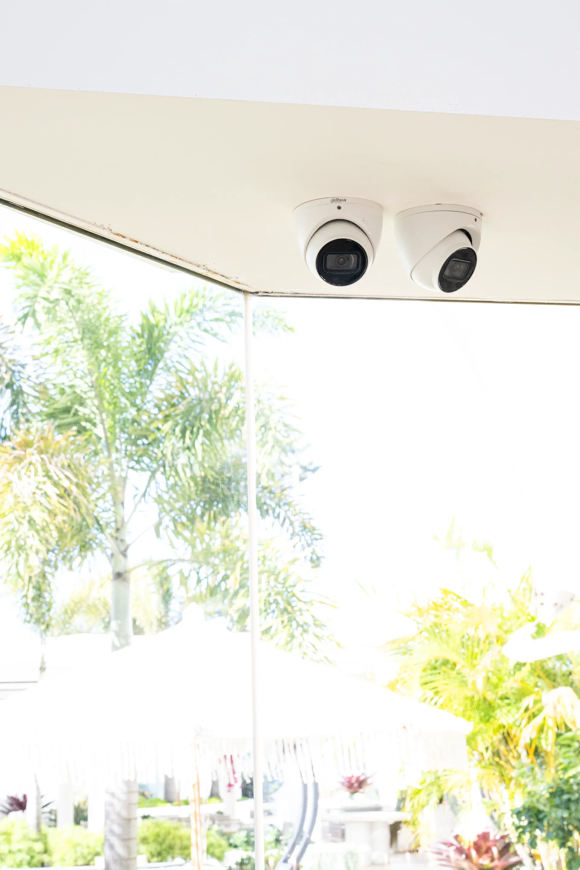 Twin dome cameras covering a poolside area