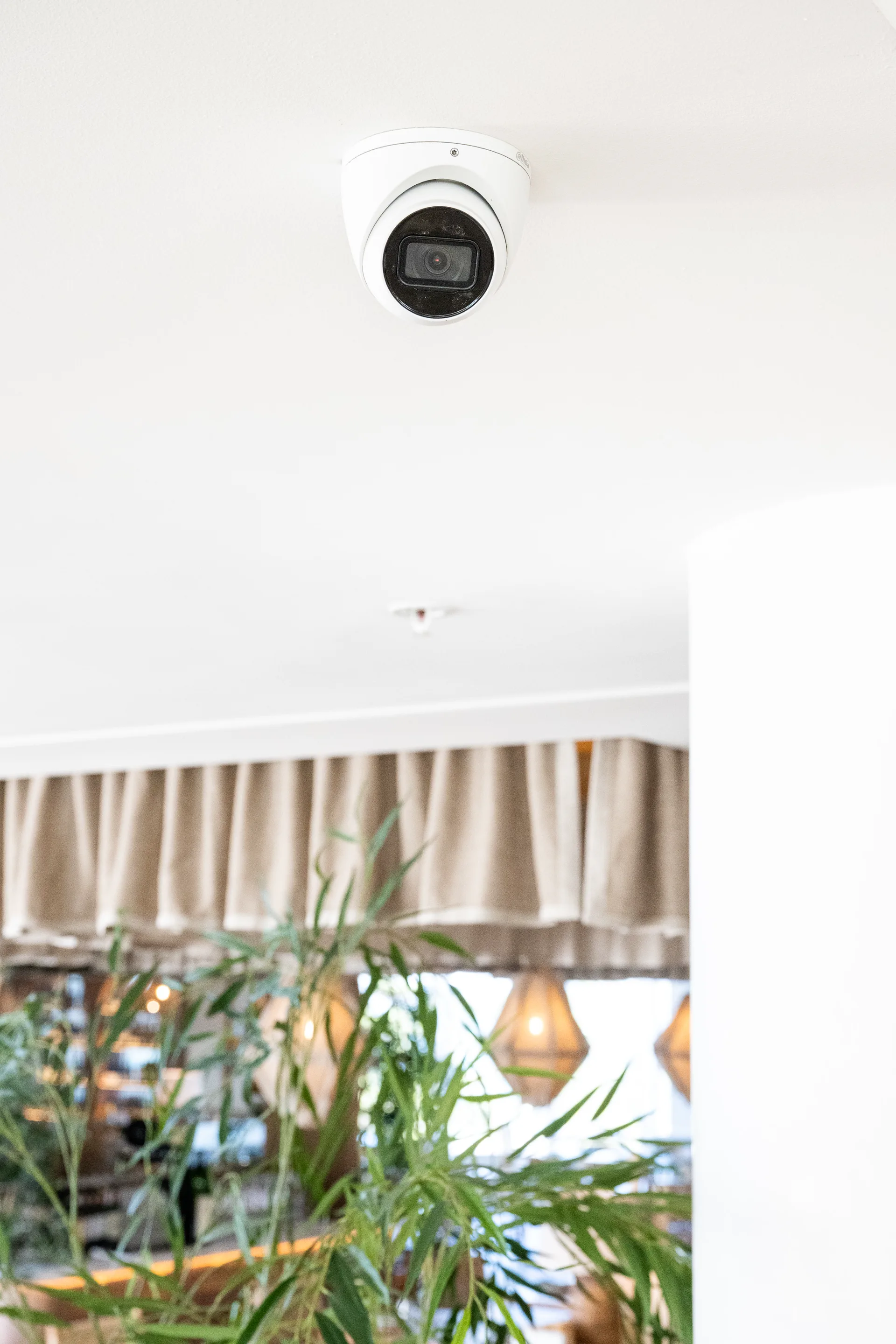 A dome camera covering a hospitality venue interior
