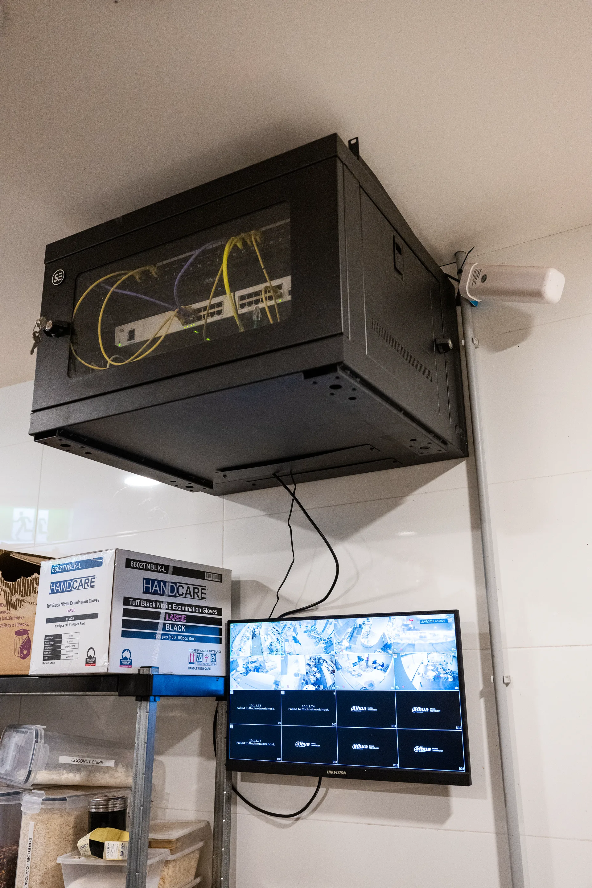A tidy comms rack installation with a live camera monitor