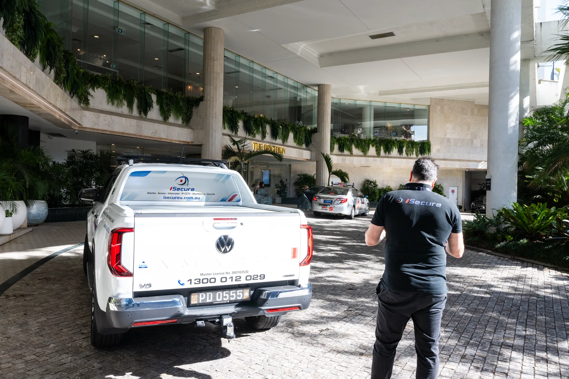An iSecure vehicle at a venue entrance during a service call