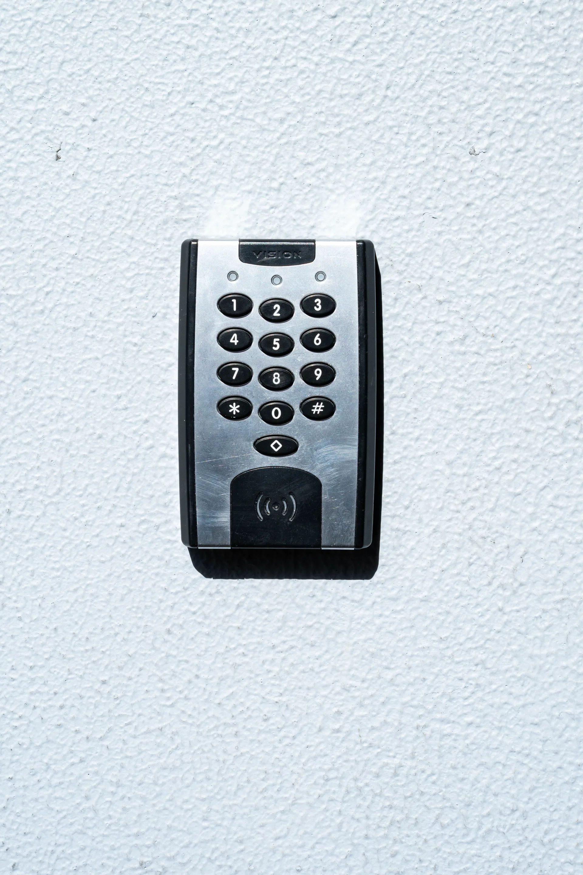 A keypad and card reader entry unit on a commercial wall
