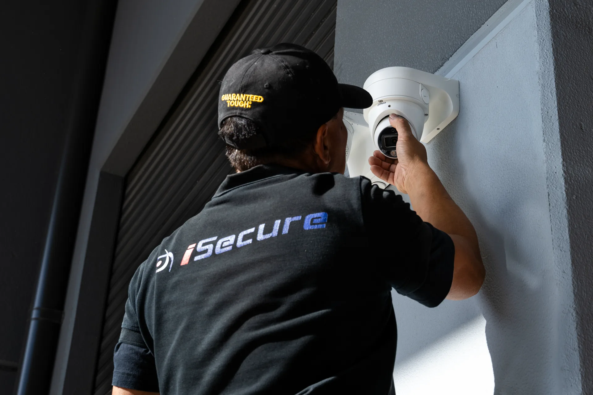 An iSecure technician adjusting an entry camera