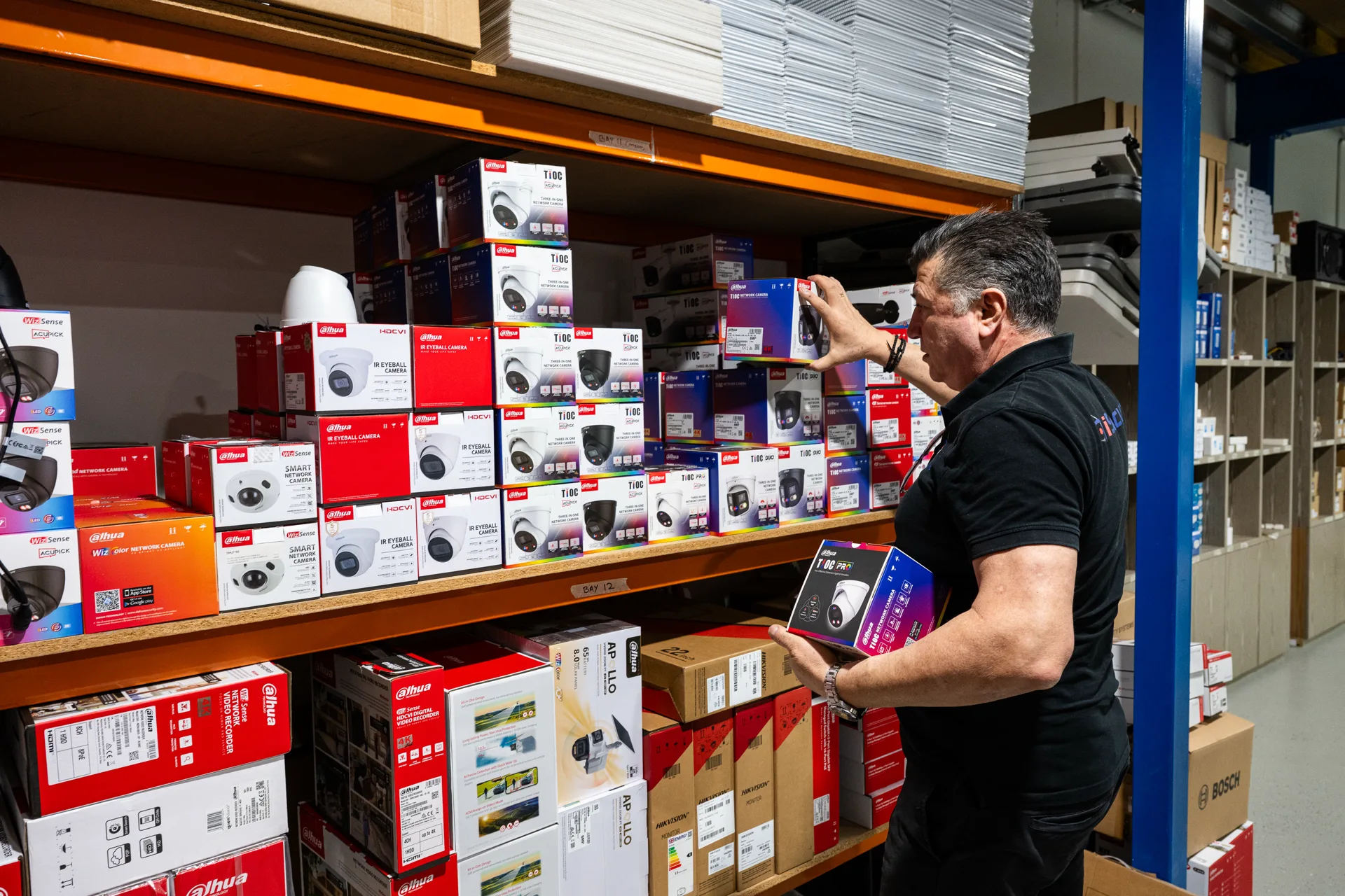 An iSecure team member picking camera stock in the warehouse