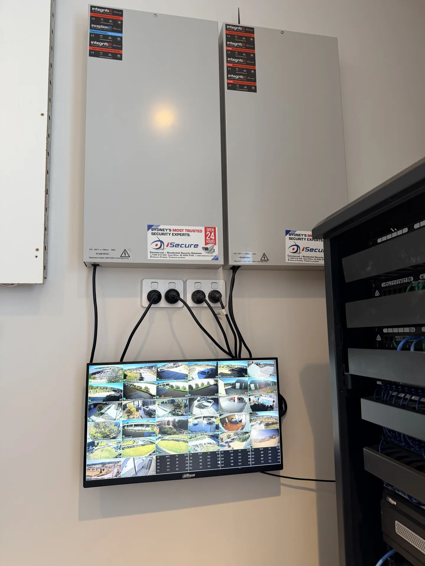 iSecure enclosures beside a live camera wall monitor